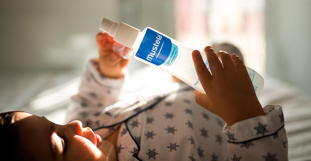 Baby with Mustela product